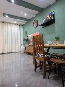 a dining room with a wooden table and chairs at Little Heaven Villa in Lomé +32 photos