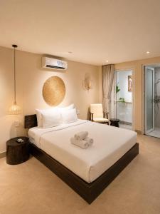a bedroom with a bed with a towel on it at HemTouch House - Nguyễn Văn Mai in Ho Chi Minh City