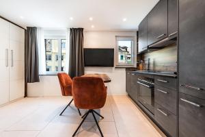 a kitchen with a table and chairs in a kitchen at CITY-APARTMENT's in Winterthur