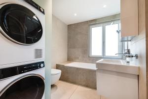 a bathroom with a washer and a sink and a washing machine at CITY-APARTMENT's in Winterthur