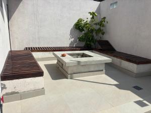 a patio with two benches and a table at Mulberry Villa in Anuradhapura