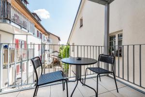a patio with two chairs and a table on a balcony at CITY-APARTMENT's in Winterthur