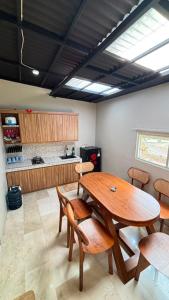 a dining room with a wooden table and chairs at Villa Alibaba E5 in Tlekung