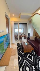 a living room with a couch and a table at Villa Alibaba E5 in Tlekung
