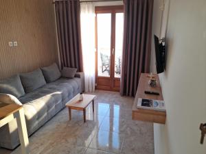 a living room with a couch and a table at ELEVER Apartments in Agia Marina