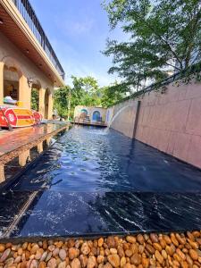 a pool of water in front of a building at Baram Villas Phong Nha in Hà Lời