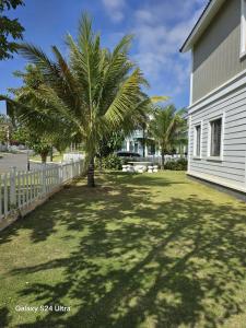 a palm tree in a yard next to a building at Villa Malibu Phan Thiet, Free Parking in Phan Thiet