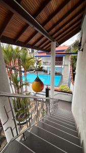 a balcony with a view of a swimming pool at Chamo Villa by DrMocktail in Beruwala
