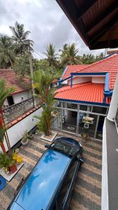 a car is parked in front of a house at Chamo Villa by DrMocktail in Beruwala