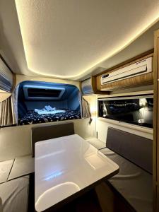 a small kitchen with a white table in an rv at Upgrade Beach Resort Infanta Quezon in Infanta
