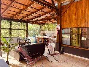 an outdoor patio with a table and chairs and a wooden ceiling at Volcano Refuge House in Fortuna