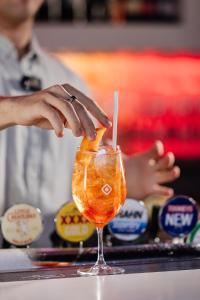 a person is making a drink in a glass at Junction Hotel in Newcastle
