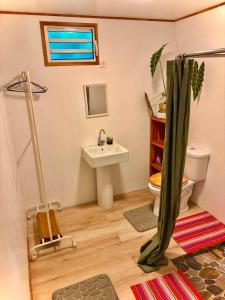 a small bathroom with a sink and a toilet at Fare Aimeho in Vaianae
