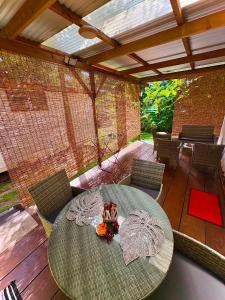 a patio with a table and chairs on a deck at Fare Aimeho in Vaianae