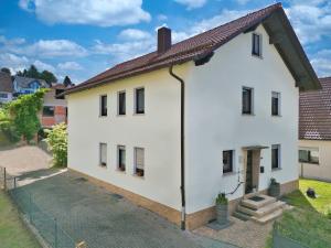 a white house with a brown roof at Nanas-Auszeit in Rothenbuch