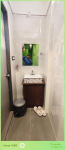 a bathroom with a sink and a toilet and a mirror at rajapalace in Zahirābād