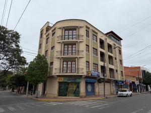 a building on the corner of a street at Altos de Belgrano Suites in Tarija