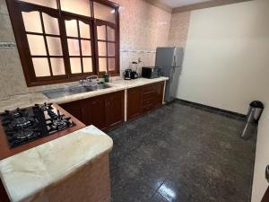 a kitchen with a sink and a stove in it at Altos de Belgrano Suites in Tarija