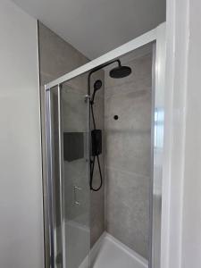 a shower with a glass door in a bathroom at Luaz - View Lodge in Dublin +17 photos