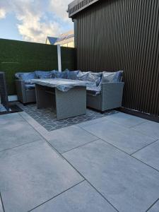 a patio with a table with a blanket on it at Luaz - View Lodge in Dublin