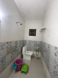 a small bathroom with a toilet and a window at Hotel White Sand Bache Stay in Aguada