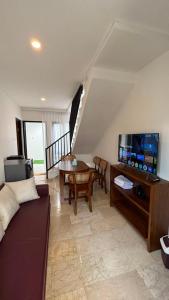 a living room with a couch and a table at Villa Alibaba D3 in Batu