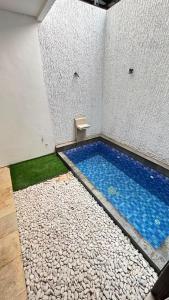 a small swimming pool in the corner of a room at Villa Alibaba D3 in Batu
