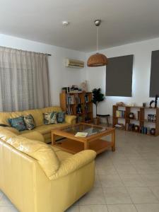 a living room with a couch and a coffee table at Villa Melita Seafront in Pefki