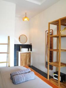 a bedroom with a bunk bed and a ladder at Tipsea Turtle Gili Trawangan in Gili Trawangan