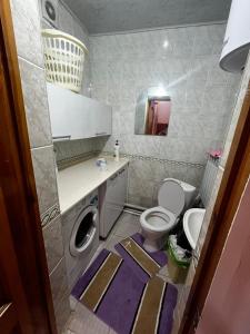 a bathroom with a toilet and a sink at Aida in Tebykty
