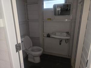 a small bathroom with a toilet and a sink at sabai resort in Pattaya South