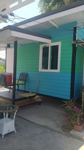 a blue and green house with a patio at sabai resort in Pattaya South