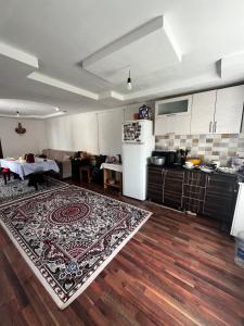 a kitchen with a rug on a wooden floor at Aida in Tebykty