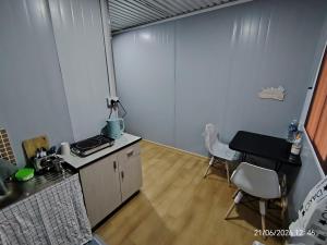 a kitchen with a table and a table and chairs at DMaro Cabin in Kampong Kundassan +14 photos