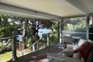 a screened in porch with a view of the water at Seasons at South Mission Beach in South Mission Beach