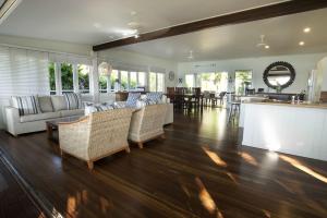 a living room with couches and a bar in a house at Seasons at South Mission Beach in South Mission Beach