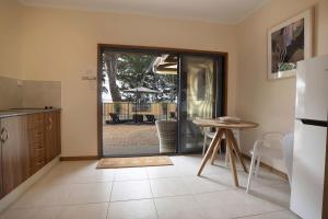a kitchen with a table and a sliding glass door at Latitude 17 Suite 2 in South Mission Beach