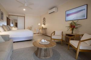 a hotel room with a bed and a living room at Latitude 17 Suite 2 in South Mission Beach