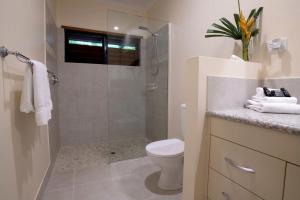 a bathroom with a shower and a toilet and a sink at Latitude 17 Suite 2 in South Mission Beach +23 photos