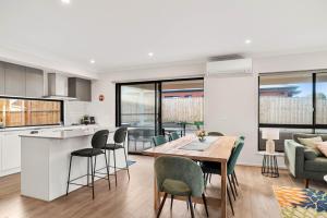 a kitchen and living room with a table and chairs at Pembrey Loop Cowes in Cowes