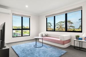 a living room with a couch and two windows at Pembrey Loop Cowes in Cowes