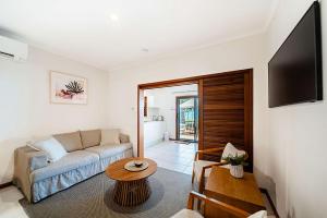 a living room with a couch and a table at Latitude 17 Suite 3 in South Mission Beach