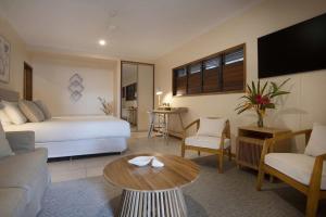 a hotel room with a bed and a couch and a table at Latitude 17 Suite 3 in South Mission Beach +29 photos