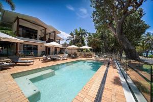 a swimming pool in front of a house at Latitude 17 Suite 4 in South Mission Beach