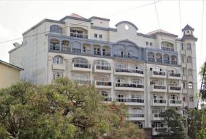 a large white building with a lot of windows at Your Quiet Home with Unbeatable location in Baguio