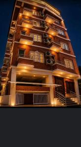 a tall building with balconies and lights on it at Hotel happy stay inn in Pashupatināth