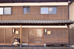 a teddy bear sitting in front of a building at Ocean Living LA FUKU 和歌浦 一棟貸し 愛犬と泊まれる海辺の宿 in Wakayama