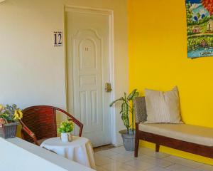 a room with a couch and a table and a door at Hotel El Tronco Inc in Boca Chica +48 photos