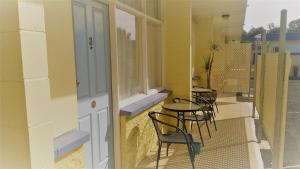 a balcony with chairs and tables and a window at Warren Motor Inn in Warren