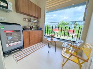 a kitchen with a large window and a table and chairs at Huko House in Ho Chi Minh City